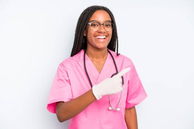 black pretty woman looking excited and surprised pointing to the side. nurse concept