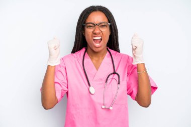 black pretty woman shouting aggressively with an angry expression. nurse concept