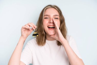 caucasian pretty woman feeling happy,giving a big shout out with hands next to mouth. new car concept