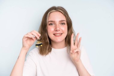 caucasian pretty woman smiling and looking friendly, showing number three. new car concept