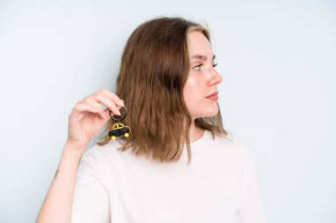 caucasian pretty woman on profile view thinking, imagining or daydreaming. new car concept