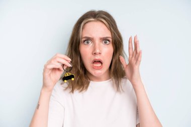 caucasian pretty woman screaming with hands up in the air. new car concept