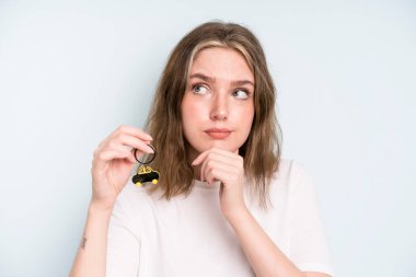 caucasian pretty woman thinking, feeling doubtful and confused. new car concept