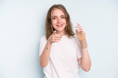 caucasian pretty woman pointing at camera choosing you. broken hand concept