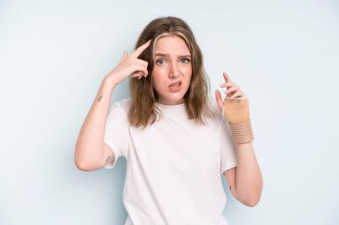 caucasian pretty woman feeling confused and puzzled, showing you are insane. broken hand concept