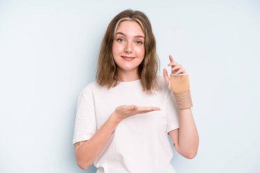 caucasian pretty woman smiling cheerfully, feeling happy and showing a concept. broken hand concept