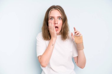 caucasian pretty woman feeling shocked and scared. broken hand concept