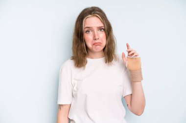 caucasian pretty woman feeling sad and whiney with an unhappy look and crying. broken hand concept