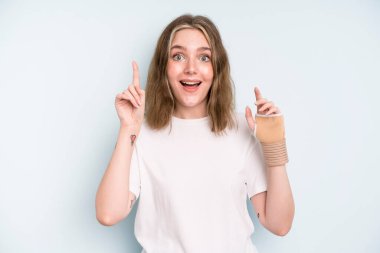 caucasian pretty woman feeling like a happy and excited genius after realizing an idea. broken hand concept