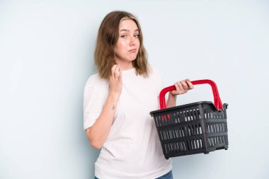 caucasian pretty woman looking arrogant, successful, positive and proud. empty shopping basket concept