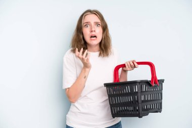 caucasian pretty woman looking desperate, frustrated and stressed. empty shopping basket concept