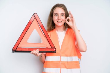 caucasian pretty woman feeling happy, showing approval with okay gesture. car emergency concept