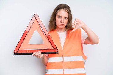 caucasian pretty woman feeling cross,showing thumbs down. car emergency concept