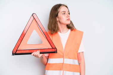 caucasian pretty woman on profile view thinking, imagining or daydreaming. car emergency concept