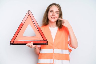 caucasian pretty woman smiling confidently pointing to own broad smile. car emergency concept