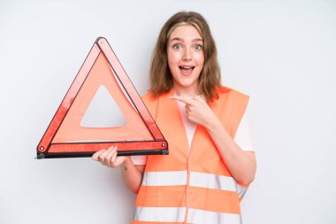 caucasian pretty woman looking excited and surprised pointing to the side. car emergency concept