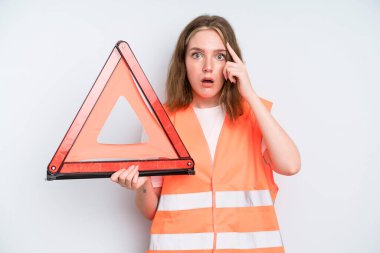 caucasian pretty woman looking surprised, realizing a new thought, idea or concept. car emergency concept