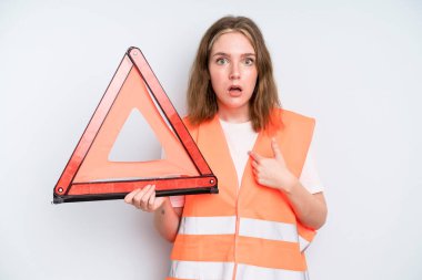 caucasian pretty woman looking shocked and surprised with mouth wide open, pointing to self. car emergency concept