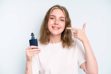caucasian pretty woman smiling confidently pointing to own broad smile. smoker with a vaper concept