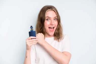 caucasian pretty woman feeling happy and facing a challenge or celebrating. smoker with a vaper concept