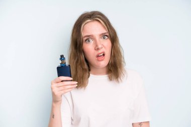 caucasian pretty woman feeling puzzled and confused. smoker with a vaper concept