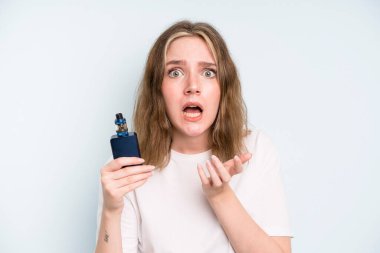 caucasian pretty woman looking desperate, frustrated and stressed. smoker with a vaper concept