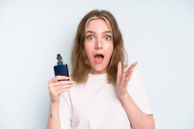 caucasian pretty woman feeling extremely shocked and surprised. smoker with a vaper concept