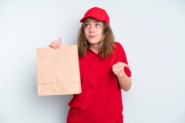 caucasian pretty woman shrugging, feeling confused and uncertain. delivery and take away concept