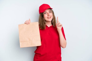 caucasian pretty woman smiling and looking friendly, showing number one. delivery and take away concept