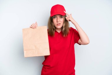 caucasian pretty woman feeling confused and puzzled, showing you are insane. delivery and take away concept
