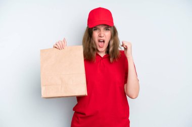 caucasian pretty woman shouting aggressively with an angry expression. delivery and take away concept