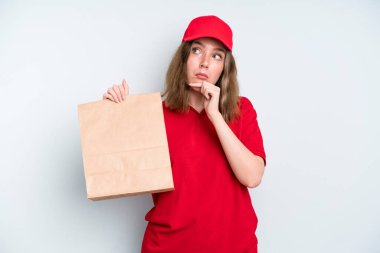caucasian pretty woman thinking, feeling doubtful and confused. delivery and take away concept
