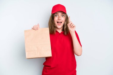 caucasian pretty woman feeling like a happy and excited genius after realizing an idea. delivery and take away concept