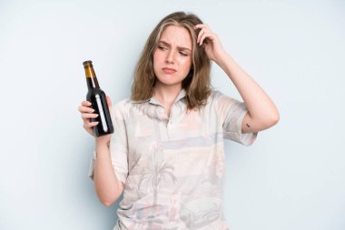 caucasian pretty woman smiling happily and daydreaming or doubting. beer concept