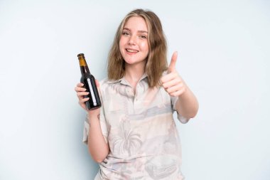 caucasian pretty woman feeling proud,smiling positively with thumbs up. beer concept