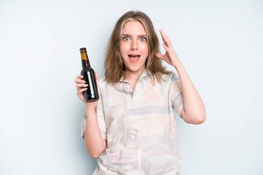 caucasian pretty woman screaming with hands up in the air. beer concept