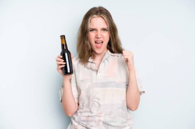caucasian pretty woman shouting aggressively with an angry expression. beer concept