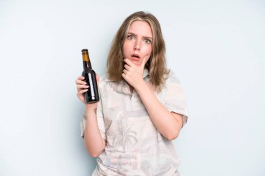 caucasian pretty woman with mouth and eyes wide open and hand on chin. beer concept