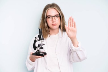 caucasian pretty woman feeling proud,smiling positively with thumbs up. science student with a microscope