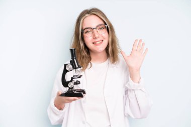 caucasian pretty woman feeling confused and puzzled, showing you are insane. science student with a microscope