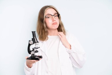 caucasian pretty woman smiling confidently pointing to own broad smile. science student with a microscope