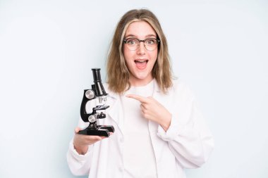 caucasian pretty woman looking arrogant, successful, positive and proud. science student with a microscope