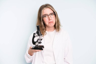 caucasian pretty woman looking surprised, realizing a new thought, idea or concept. science student with a microscope