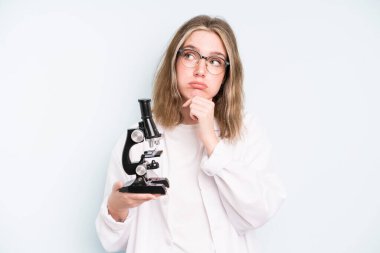 caucasian pretty woman screaming with hands up in the air. science student with a microscope