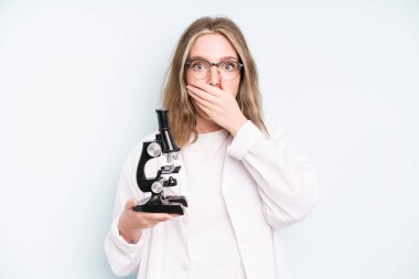 caucasian pretty woman feeling extremely shocked and surprised. science student with a microscope