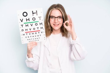 caucasian pretty woman feeling shocked,laughing and celebrating success. optical vision test concept