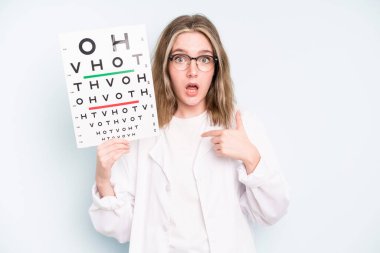 caucasian pretty woman looking very shocked or surprised. optical vision test concept