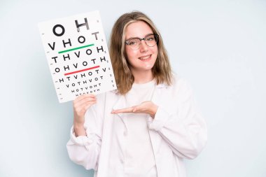 caucasian pretty woman smiling cheerfully, feeling happy and pointing to the side. optical vision test concept