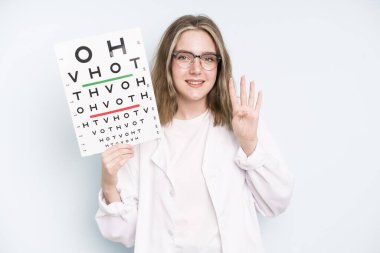 caucasian pretty woman smiling and looking friendly, showing number three. optical vision test concept
