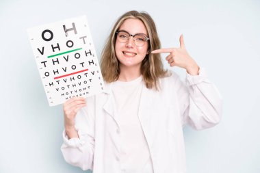 caucasian pretty woman making capice or money gesture, telling you to pay. optical vision test concept